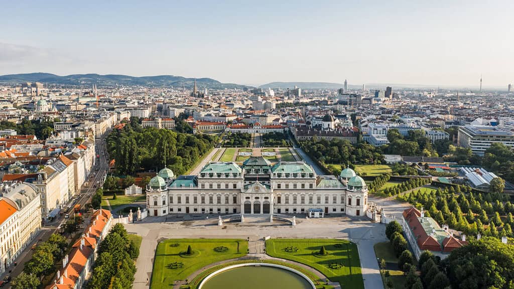 Aerial view of Vienna with historic palace and gardens.
