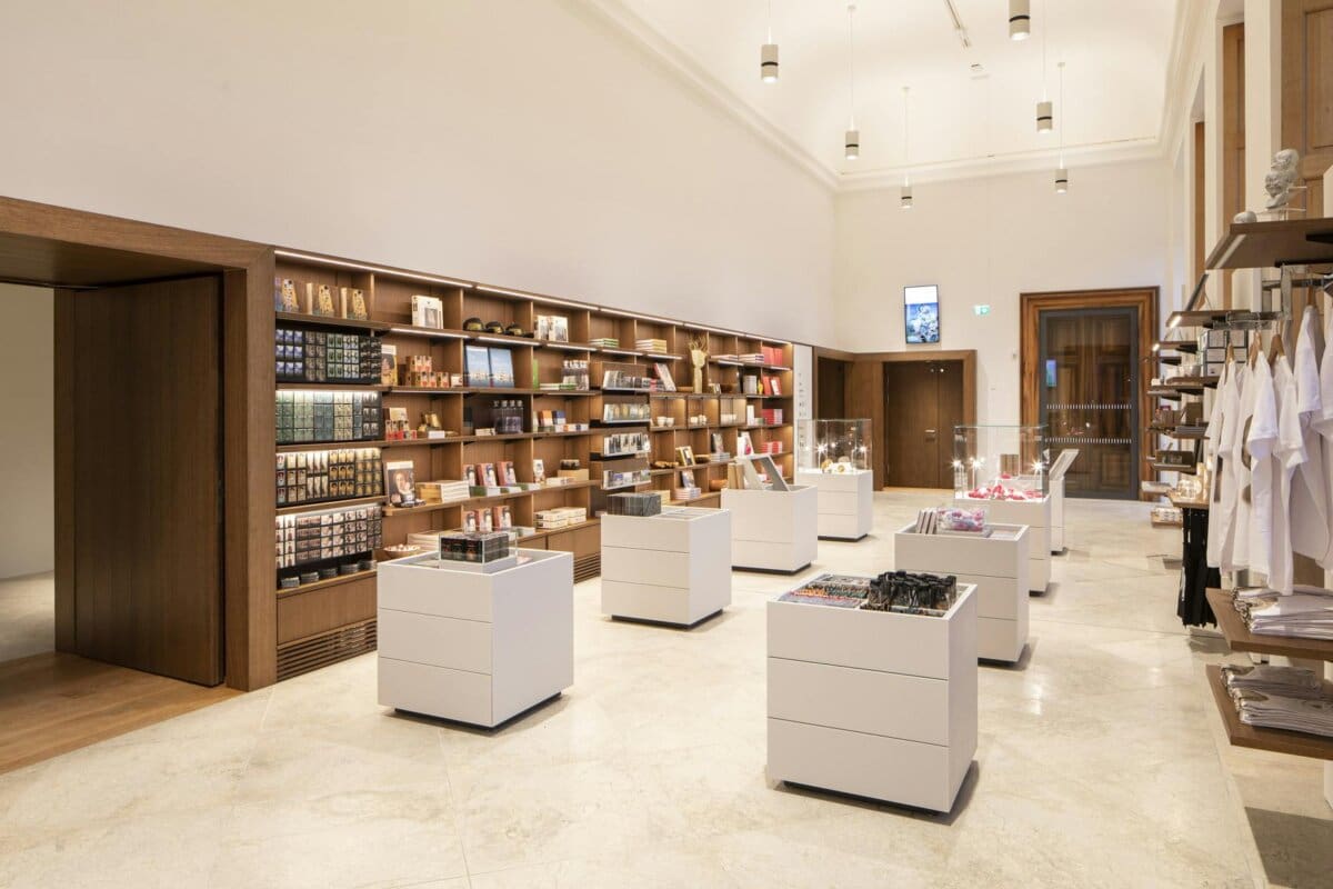 Modern gift shop with shelves and display tables.